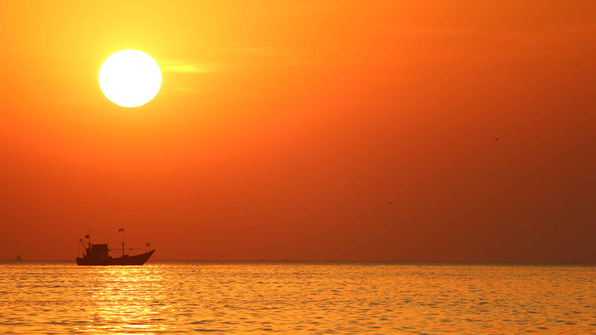 A sunset beyond the sea, waiting for someone returning from the waves